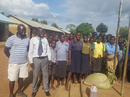 Students standing next to sacks of grain