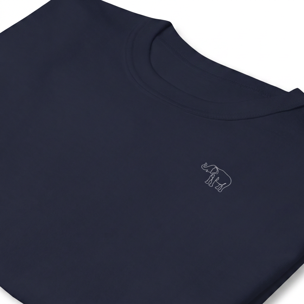 Heritage Tee — Navy — Detail — embroidered elephant emblem at collar.